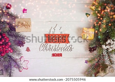 Christmas tree branches with snow and paper card note. Flat lay. Nature New Year concept.