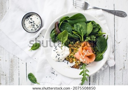 Vegetable hash browns with smoked salmon and leaf salad (low carb) Royalty-Free Stock Photo #2075508850