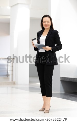 Portrait Of Successful A middle-aged Asian businesswoman Holding tablet smiling to camera