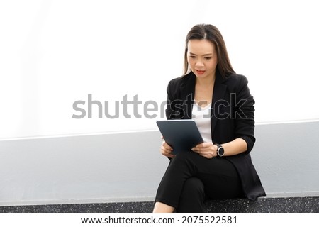Portrait Of Successful A middle-aged Asian businesswoman Holding tablet smiling to camera