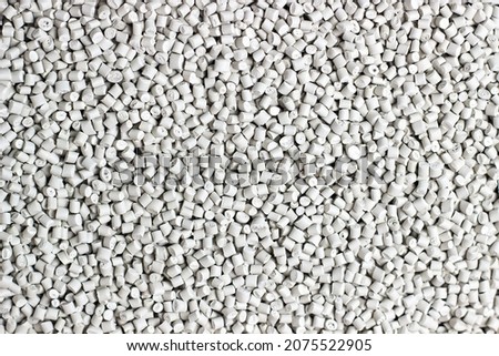 Many white and gray granules of polypropylene, polyamide. Background. Plastic and polymer industry, industry. Microplastic products. Royalty-Free Stock Photo #2075522905