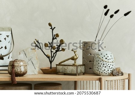 Beautiful living room interior design with candlectick, vases, mineral and personal accessories on the wooden console. Copy space. Template.