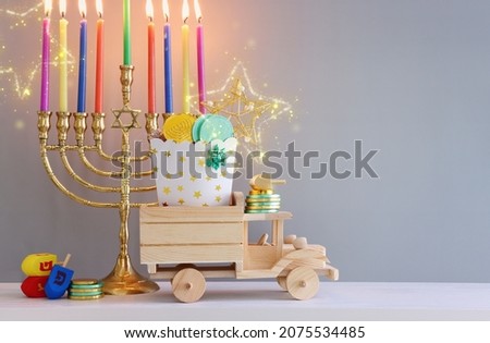 Religion image of jewish holiday Hanukkah background of spinning tops with letters that mean, A 
GREAT MIRACLE HAPPENED HERE, and menorah