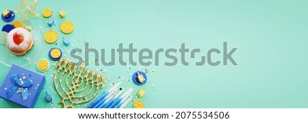 Religion image of jewish holiday Hanukkah background of spinning tops with letters that mean, A 
GREAT MIRACLE HAPPENED HERE, donuts and menorah (traditional candelabra)