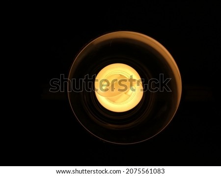 Abstract yellow neon background. Luminous swirling. Glowing spiral cover. Black elegant. Halo around. İsolated light source. Spark particle. Power isolated. Glint glitter. Space tunnel.