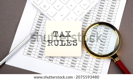 TAX RULES text on sticker on chart ,with calculator and magnifier