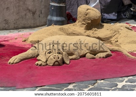 Dog made of sand street art