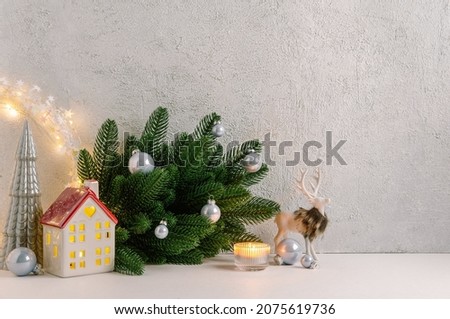 Christmas composition of Christmas decorations, pine branches, candle, deer and  copy space for text. Template.