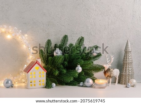 Christmas composition of Christmas decorations, pine branches, candle, deer and  copy space for text. Template.