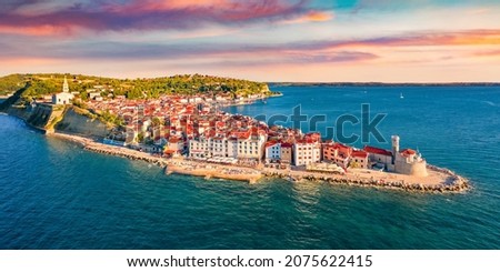 Сharm of the ancient cities of Europe. Bright morning cityscape of Piran town. Stunning summer scene of Slovenia’s Adriatic coast with beautiful Venetian architecture. View from flying drone. Royalty-Free Stock Photo #2075622415