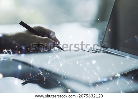 Creative concept of wireless technology and hand writing in notebook on background with laptop. Big data and database concept. Multiexposure