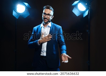 Motivational speaker with headset performing on stage Royalty-Free Stock Photo #2075636632