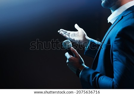 Motivational speaker with microphone performing on stage, closeup. Space for text Royalty-Free Stock Photo #2075636716