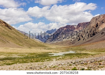 The Kargyak river flowing through the mountains of the Zanskar range on the Darcha Padum trekking route in the Indian Himalaya.