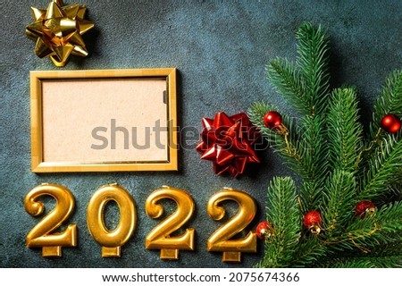 Christmas photo frame mock up template with decoration on dark background. View from above. New year mockup. New year composition with champagne bottle and decor. New year 2022.