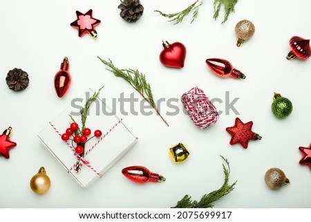 Christmas composition. Gifts, fir tree branches, red decorations on white background.Flat lay, top view, copy space
