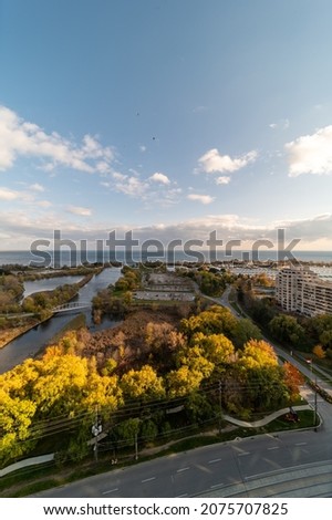 Drone views of Humber bay park overlooking the lake  and fall tree colours by Parklawn and lakeshore 