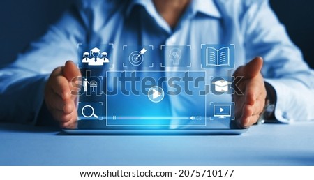 Person who attends online lessons on a virtual screen tablet. E-learning education, internet lessons and online webinar. Education internet Technology.
 Royalty-Free Stock Photo #2075710177