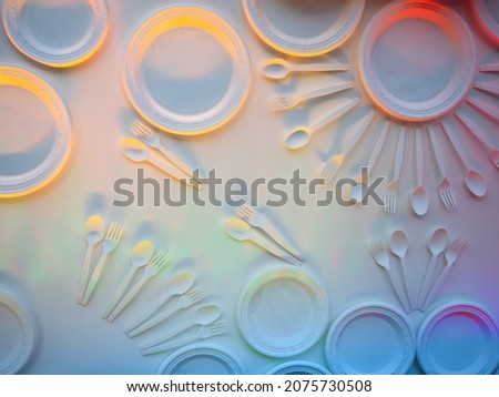 degradable plastic spoon and fork and paper dish on white background, it made of self degrade material , also self decompose and digest to small piece of substance by time and nature