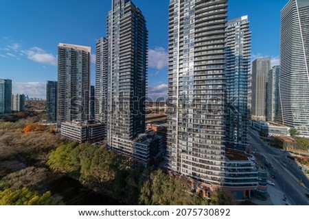 Parklawn and Lakeshore drone views with condos and fall colour trees with a trail  