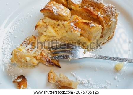 A piece of apple pie on a white plate.