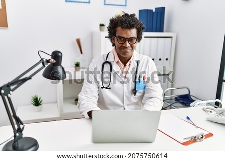 Young south east man wearing doctor uniform working at clinic