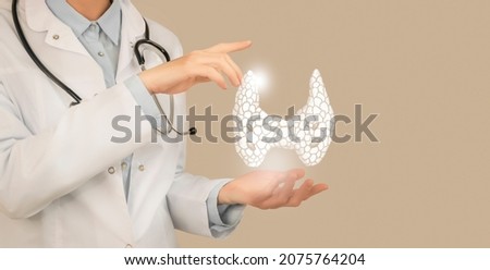 Female doctor holding virtual Thyroid Gland in hand. Handrawn human organ, copy space on right side, beige color. Healthcare hospital service concept stock photo Royalty-Free Stock Photo #2075764204