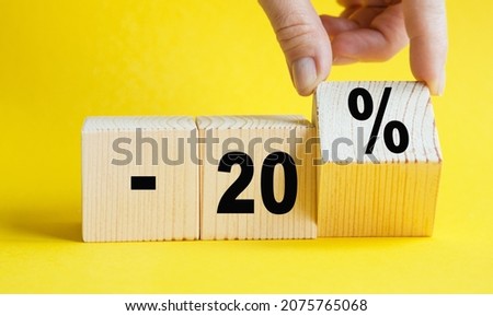 Interest rate financial and mortgage rates concept. Hand putting wood cube block with icon percentage symbol. Concept of sale and discount.