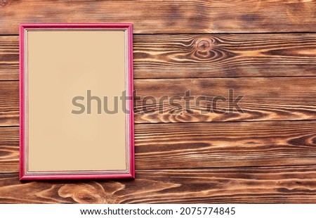 Mockup frame on rustic wooden background. View from above.