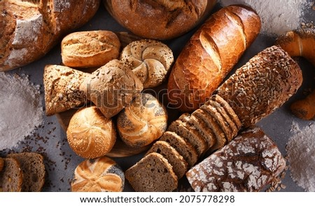 Assorted bakery products including loafs of bread and rolls Royalty-Free Stock Photo #2075778298