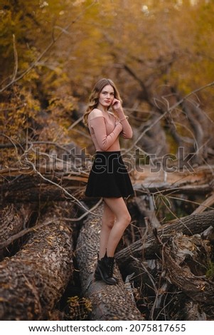 A girl walks in the autumn forest, enjoys life