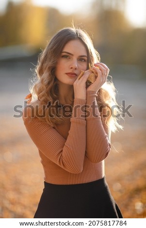 A girl walks in the autumn forest, enjoys life