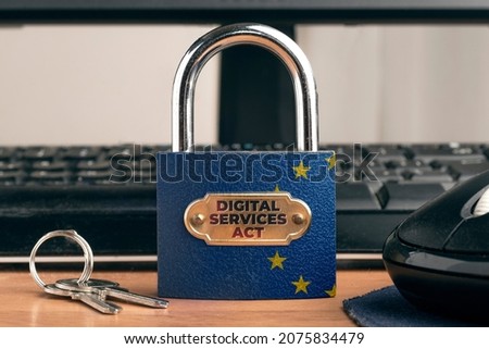 Digital services act (DSA) concept: lock with European Union Flag near to a computer. Royalty-Free Stock Photo #2075834479