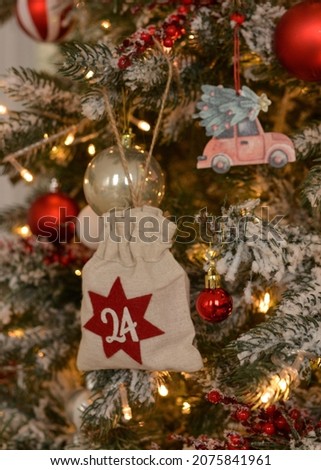 Advent calendar .Advent calendar in the form of an eco bag hangs on the Christmas tree.Christmas background. Royalty-Free Stock Photo #2075841961