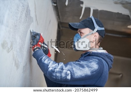 fire damage and restoration indoor interior. removing damaged paint layer Royalty-Free Stock Photo #2075862499