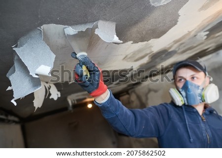 fire damage and restoration indoor interior. removing damaged paint layer Royalty-Free Stock Photo #2075862502