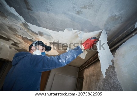 fire damage and restoration indoor interior. removing damaged paint layer Royalty-Free Stock Photo #2075862505