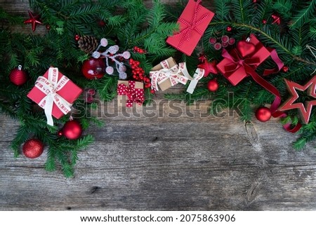 Christmas gift giving and zero waste concept - wrapped christmas gift box, border on wooden background with copy space