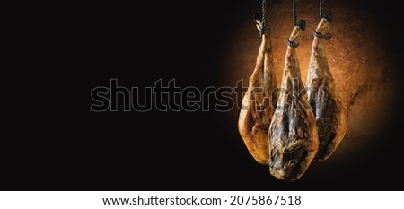 Dry Spanish ham, Jamon Serrano, Bellota, Italian Prosciutto Crudo or Parma ham.Slicing Spanish íberic ham. Spanish jamon and traditional food. Royalty-Free Stock Photo #2075867518