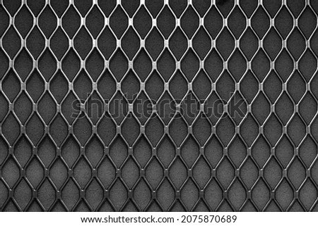 Metal grid with geometric pattern of rhombi, background. Black metallic modern background Royalty-Free Stock Photo #2075870689