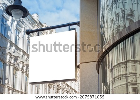 Mock up. Blank white rectangular shape signboard on the wall of classical architecture building. Signage of shop, store, cafe, restaurant