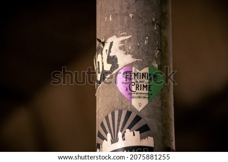 Feminism sign on a lamp post Royalty-Free Stock Photo #2075881255