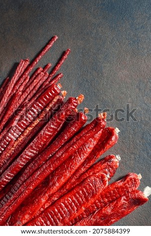 Appetizing dried sausages are many, of different sizes and shapes. Close up, top view