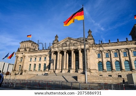 German Bundestag. Berlin, building of German Parliament. National flags flying on a flagpole in a front of Reichstag building in Berlin, Germany.  Royalty-Free Stock Photo #2075886931