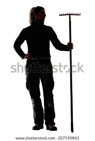 One woman standing with garden rake on isolated white background