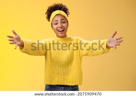 Friendly hospitable charming millennial stylish female hosting party welcoming guest inviting come in extend arms sideways warm welcome hug greeting wanna embrace cuddle, smiling cute Royalty-Free Stock Photo #2075909470