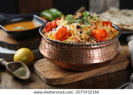 Traditional Indian dish shrimp biryani. tikka masala. Spicy shrimp tikka masala curry in bowl, Indian bread naan, fresh cilantro. Indian style dinner. Space for text. Top view. Indian food
 Royalty-Free Stock Photo #2075932186