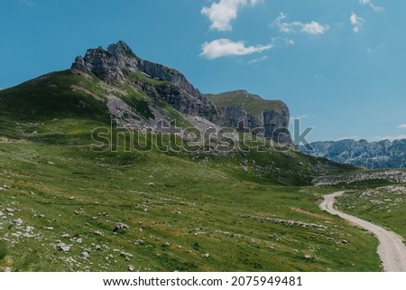 Amaizing view on Durmitor mountains, National Park, Mediterranean, Montenegro, Balkans, Europe. Bright summer view from Sedlo pass. The road near the house in the mountains.