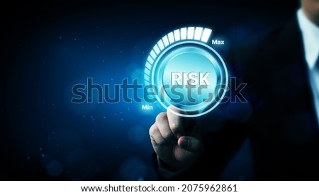Risk management business strategy planning concept. Businessman hand pointing risk level Royalty-Free Stock Photo #2075962861
