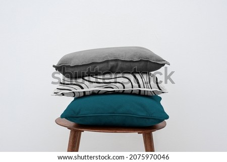 Minimal linen cushion covers on a chair Royalty-Free Stock Photo #2075970046